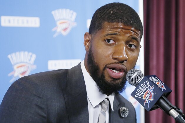 FILE - In this July 12, 2017, file photo, Oklahoma City Thunder forward Paul George answers a question at his first news conference since Oklahoma City's blockbuster trade with the Indiana Pacers, in Oklahoma City. George travels back to Indiana on Dec. 13, 2017, for the first time since the Pacers surprisingly dealt him to Oklahoma City. (AP Photo/Sue Ogrocki, File)