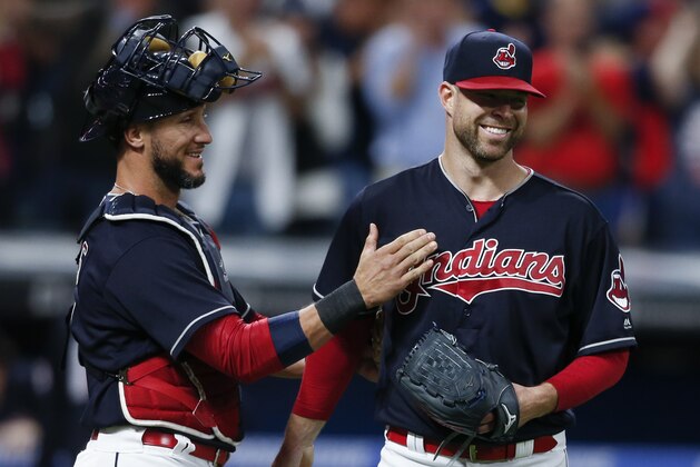 Cleveland Indians starting pitcher Corey Kluber, right, and catcher Yan Gomes celebrate a 2-0 victory over the Detroit Tigers in a baseball game, Tuesday, Sept. 12, 2017, in Cleveland. (AP Photo/Ron Schwane)