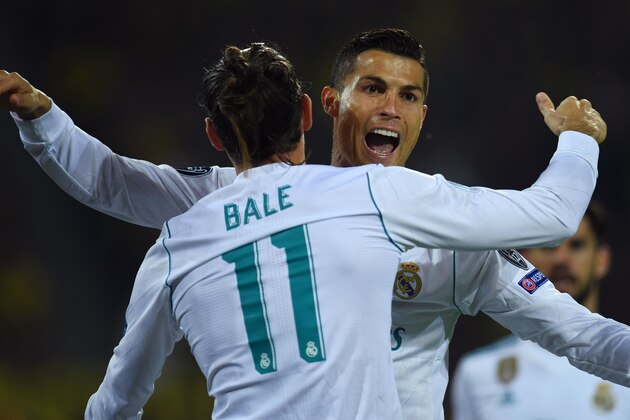 Real Madrid's forward from Portugal Cristiano Ronaldo (R) celebrates scoring with his teammate forward from Wales Gareth Bale during the UEFA Champions League Group H football match BVB Borussia Dortmund v Real Madrid in Dortmund, western Germany on September 26, 2017. / AFP PHOTO / Patrik STOLLARZ        (Photo credit should read PATRIK STOLLARZ/AFP/Getty Images)