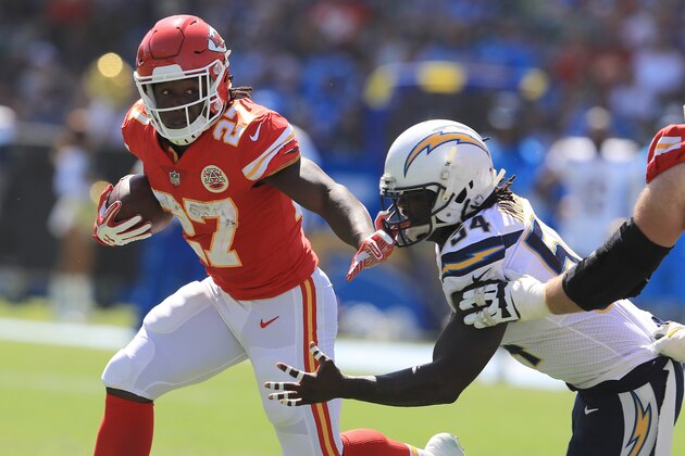 CARSON, CA - SEPTEMBER 24:  Kareem Hunt #27 of the Kansas City Chiefs eludes Melvin Ingram #54 of the Los Angeles Chargers to gain extra yardage during the NFL game at the StubHub Center on September 24, 2017 in Carson, California.  (Photo by Sean M. Haffey/Getty Images)