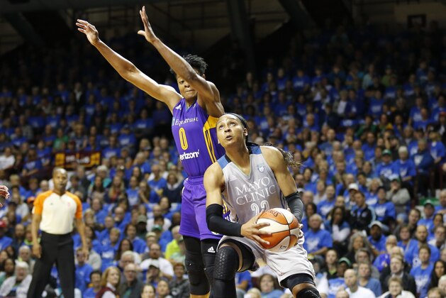 Minnesota Lynx's Maya Moore, right, drives as Los Angeles Sparks' Alana Beard defends in the first half of Game 2 in the WNBA basketball finals Tuesday, Sept. 26, 2017, in Minneapolis. (AP Photo/Jim Mone)
