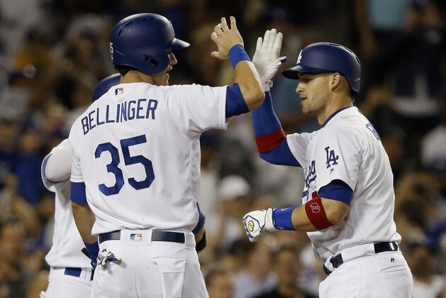 Los Angeles Dodgers' Yasmani Grandal, right, gets congratulations from Cody Bellinger (35) after hitting a three-run home run against the San Diego Padres during the fifth inning of a baseball game in Los Angeles, Tuesday, Sept. 26, 2017. (AP Photo/Alex Gallardo)