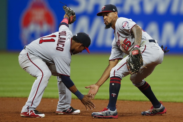 Minnesota Twins' Jorge Polanco (11) and Byron Buxton (25) celebrate an 8-6 victory over the Cleveland Indians in a baseball game, Tuesday, Sept. 26, 2017, in Cleveland. (AP Photo/Ron Schwane)