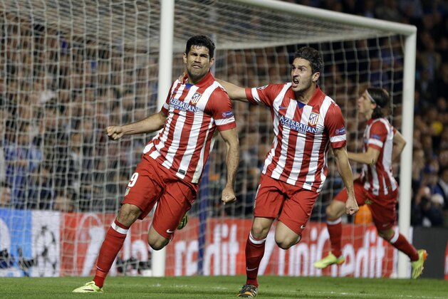 CAPTION CORRECTS THE DATE - FILE - In this Wednesday, April 30, 2014 file photo, Atletico's Diego Costa, left celebrates with teammate Koke after he scored a penalty during their Champions League semifinal second leg soccer match against Chelsea at Stamford Bridge Stadium in London. Atletico Madrid and Chelsea on Thursday, Sept. 21 say they have reached an agreement for the transfer of striker Diego Costa to the Spanish club. Chelsea says it gave Costa permission to travel to Madrid to undergo a medical and finalize the contract details with his former club. (AP Photo/Kirsty Wigglesworth, file)