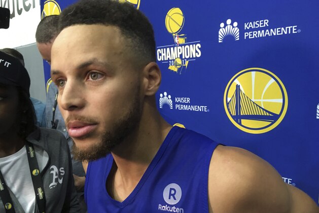 Golden State Warriors Stephen Curry takes questions from the media after NBA basketball practice in Oakland, Calif., Saturday, Sept. 23, 2017. President Donald Trump doubled down on denouncing protests by NFL players and rescinded NBA star Stephen Curry's White House invitation on Saturday, a series of tweets that quickly inflamed football and basketball stars and even prompted LeBron James to call the president a