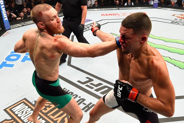 LAS VEGAS, NV - AUGUST 20:   (L-R) Conor McGregor of Ireland punches Nate Diaz in their welterweight bout during the UFC 202 event at T-Mobile Arena on August 20, 2016 in Las Vegas, Nevada. (Photo by Josh Hedges/Zuffa LLC/Zuffa LLC via Getty Images)