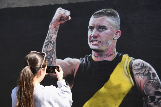 MELBOURNE, AUSTRALIA - SEPTEMBER 26:  People take photos of a Dustin Martin mural painted on Rownea Corner Store in Richmond on September 26, 2017 in Melbourne, Australia. The Richmond Tigers will play the Adelaide Crows in Saturday's AFL Grand Final at the MCG. Their first Grand Final appearance since 1982.  (Photo by Quinn Rooney/Getty Images)