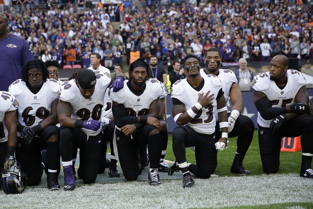 Baltimore Ravens players kneel down during the playing of the U.S. national anthem before an NFL football game against the Jacksonville Jaguars at Wembley Stadium in London, Sunday Sept. 24, 2017. (AP Photo/Matt Dunham)