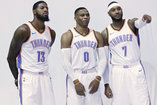 Oklahoma City Thunder's Paul George (13), Russell Westbrook (0) and Carmelo Anthony (7) pose for photos during an NBA basketball media day in Oklahoma City, Monday, Sept. 25, 2017. (AP Photo/Sue Ogrocki)