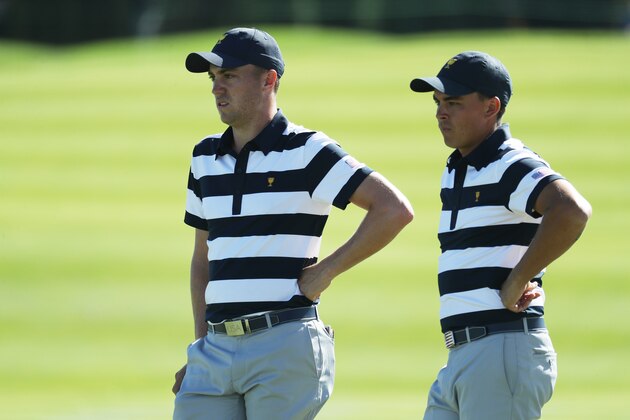 JERSEY CITY, NJ - SEPTEMBER 28:  Rickie Fowler and Justin Thomas of the U.S. Team talk on the eighth green as they play against Hideki Matsuyama of Japan and the International Team and Charl Schwartzel of South Africa and the International Team during Thursday foursome matches of the Presidents Cup at Liberty National Golf Club on September 28, 2017 in Jersey City, New Jersey.  (Photo by Rob Carr/Getty Images)
