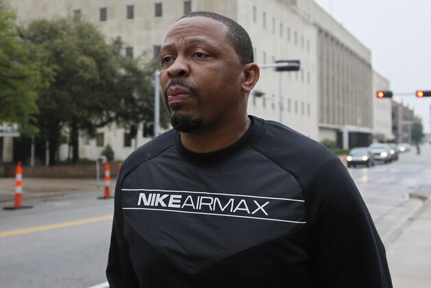 Lamont Evans, an assistant basketball coach at Oklahoma State University, leaves the federal courthouse following a court appearance in Oklahoma City, Wednesday, Sept. 27, 2017. Evans is facing federal charges in conjunction with a wide probe of fraud and corruption in the NCAA. (AP Photo/Sue Ogrocki)
