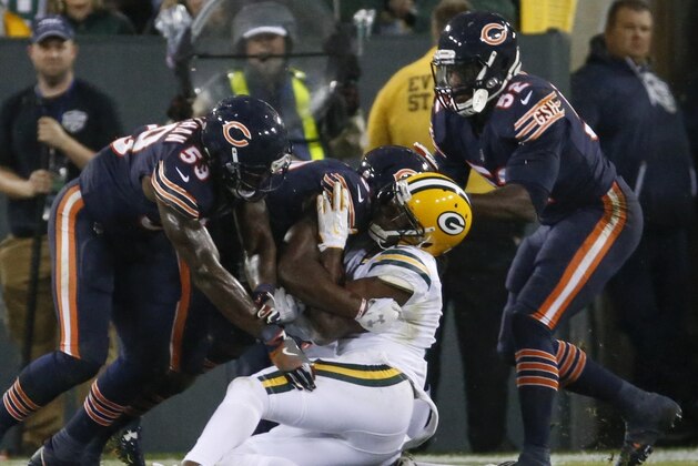Green Bay Packers' Davante Adams goes down after being hit in the head during the second half of an NFL football game against the Chicago Bears Thursday, Sept. 28, 2017, in Green Bay, Wis. (AP Photo/Mike Roemer)