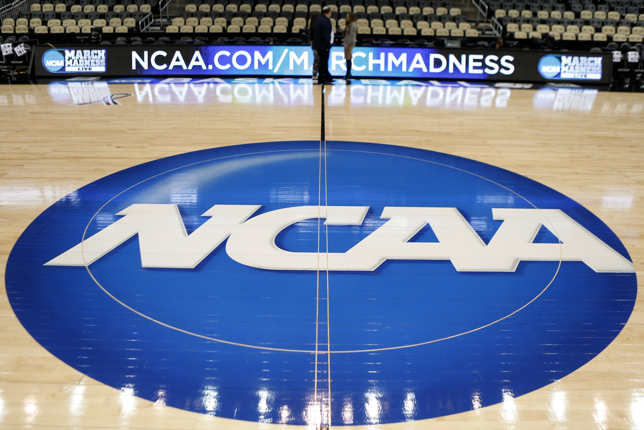 FILE - In this March 18, 2015, file photo, the NCAA logo is at center court as work continues at The Consol Energy Center in Pittsburgh, for the NCAA college basketball second and third round games. The NCAA is moving toward reforming transfer rules. There is much work to be done and any drastic changes are likely a few years away. New transfer rules will be rooted in academics, and could give higher achieving students more freedom while limiting who might be less likely to graduate if they switch schools.(AP Photo/Keith Srakocic, File) FILE - In this March 18, 2015, file photo, the NCAA logo is at center court as work continues at The Consol Energy Center in Pittsburgh, for the NCAA college basketball second and third round games. The NCAA is moving toward reforming transfer rules. There is much work to be done and any drastic changes are likely a few years away. New transfer rules will be rooted in academics, and could give higher achieving students more freedom while limiting who might be less likely to graduate if they switch schools.(AP Photo/Keith Srakocic, File)