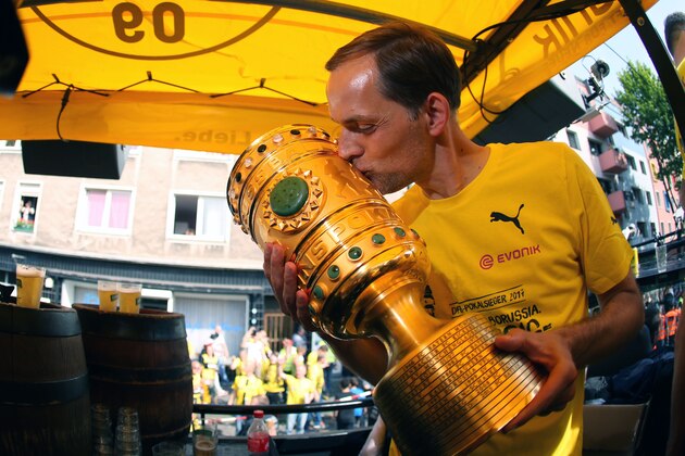 Dortmund's head coach Thomas Tuchel kisses the trophy as they arrive at Borsigplatz during celebrations after winning the German Cup final (DFB Pokalfinale) in Dortmund, western Germany, on May 28, 2017. / AFP PHOTO / POOL / Ina FASSBENDER        (Photo credit should read INA FASSBENDER/AFP/Getty Images)