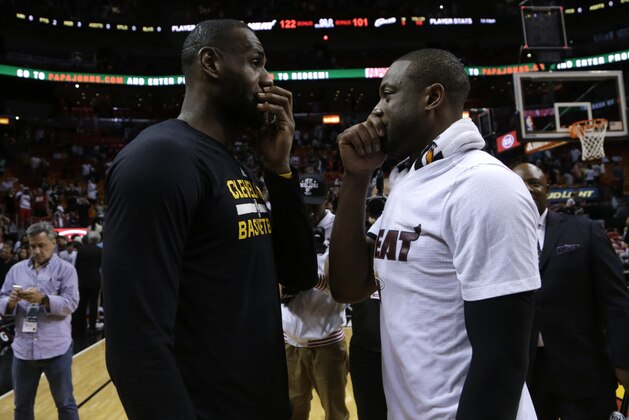 Cleveland Cavaliers forward LeBron James, left, and Miami Heat guard Dwyane Wade talk after an NBA basketball game, Saturday, March 19, 2016, in Miami. The Heat defeated the Cavaliers 122-101. (AP Photo/Lynne Sladky)