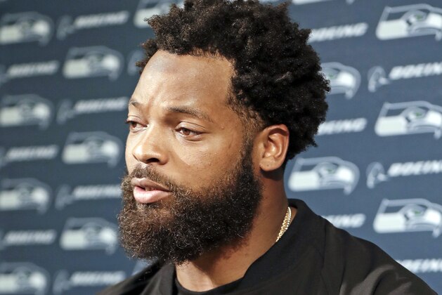 FILE - In this Sept. 24, 2017 file photo, Seattle Seahawks defensive end Michael Bennett speaks at a news conference after an NFL football game against the Tennessee Titans in Nashville, Tenn. Las Vegas police are expected Friday, Sept. 29, 2017 to make public their findings of Bennett's accusation that he was officers profiled him for racially motivated excessive force when he was stopped at gunpoint and handcuffed following a report of gunfire at an after-hours club at a casino-hotel. (AP Photo/James Kenney, File)