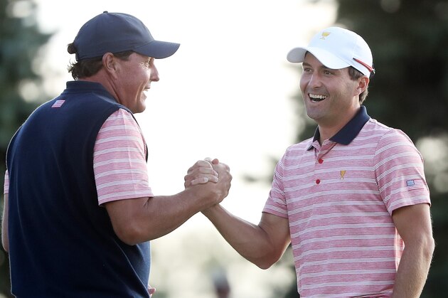 JERSEY CITY, NJ - SEPTEMBER 29:  Phil Mickelson and Kevin Kisner of the U.S. Team celebrate on the 18th green after defeating Marc Leishman and Jason Day of Australia and the International Team one up during Friday four-ball matches of the Presidents Cup at Liberty National Golf Club on September 29, 2017 in Jersey City, New Jersey.  (Photo by Sam Greenwood/Getty Images)