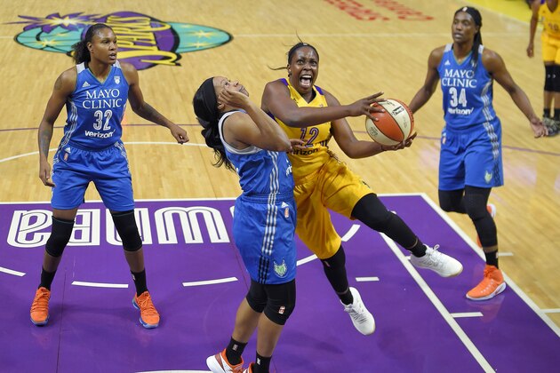 Los Angeles Sparks guard Chelsea Gray, second from right, shoots as Minnesota Lynx forward Rebekkah Brunson, left, guard Jia Perkins, second from left, and center Sylvia Fowles defend during the first half in Game 3 of a WNBA basketball finals game, Friday, Sept. 29, 2017, in Los Angeles. (AP Photo/Mark J. Terrill)