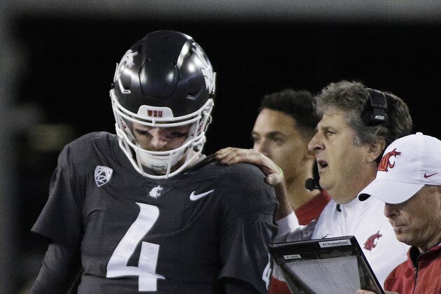 Washington State coach Mike Leach, right, speaks with quarterback Luke Falk during the first half of an NCAA college football game against Southern California in Pullman, Wash., Friday, Sept. 29, 2017. (AP Photo/Young Kwak)