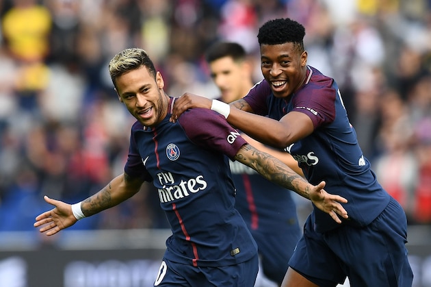 Paris Saint-Germain's Brazilian forward Neymar is congratuled by Paris Saint-Germain's French defender Presnel Kimpembe after scoring a free kick during the French L1 football match Paris Saint-Germain (PSG) vs Bordeaux (FCGB) on September 30, 2017 at the Parc des Princes stadium in Paris. / AFP PHOTO / FRANCK FIFE        (Photo credit should read FRANCK FIFE/AFP/Getty Images)
