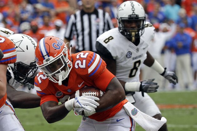 Florida running back Lamical Perine (22) runs for a 1-yard touchdown past Vanderbilt cornerback Joejuan Williams (8) during the first half of an NCAA college football game, Saturday, Sept. 30, 2017, in Gainesville, Fla. (AP Photo/John Raoux)