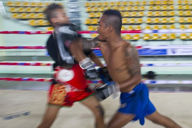 TO GO WITH Myanmar-sport-boxing-equality-culture,FEATURE by Kelly Macnamara This photo taken on July 3, 2015 shows fighter Daw Na Aung (R) practicing Myanmar's homespun martial art Lethwei -- a sport that encourages head-butting and grants victory by knock-out only --  in Yangon. Lethwei fighters say their sport is the toughest member of Southeast Asia's kickboxing family, leaving Thailand's more famous Muay Thai in the blood-flecked dust thanks to its disdain for gloves and use of skull-cracking head-butts.    AFP PHOTO / Ye Aung THU        (Photo credit should read Ye Aung Thu/AFP/Getty Images)