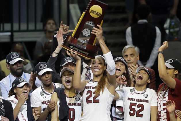 South Carolina forward A'ja Wilson (22) holds up the trophy as she celebrates with teammates after their win over Mississippi State in the final of the NCAA women's Final Four college basketball tournament, Sunday, April 2, 2017, in Dallas. South Carolina won 67-55. (AP Photo/Eric Gay)
