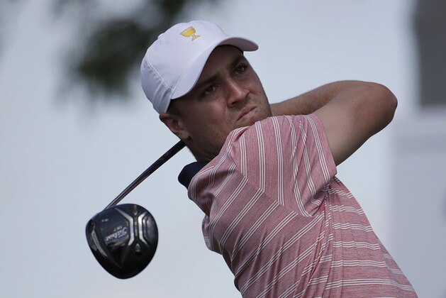 Justin Thomas hits from the second tee during the four-ball golf matches on the second day of the Presidents Cup at Liberty National Golf Club in Jersey City, N.J., Friday, Sept. 29, 2017. (AP Photo/Julio Cortez)