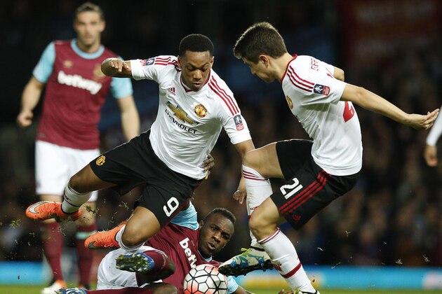 United’s Anthony Martial, left, United’s Ander Herrera, right, and West Ham’s Michail Antonio challenge for the ball during the English FA Cup quarterfinal replay soccer match between West Ham and Manchester United at Boleyn Ground stadium in London, Wednesday, April 13, 2016.(AP Photo/Alastair Grant)