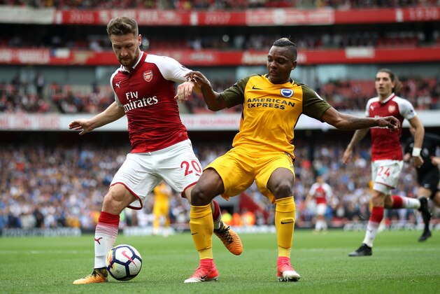 LONDON, ENGLAND - OCTOBER 01:  Shkodran Mustafi of Arsenal and Jose Izquierdo of Brighton and Hove Albion battle for possession during the Premier League match between Arsenal and Brighton and Hove Albion at Emirates Stadium on October 1, 2017 in London, England.  (Photo by Julian Finney/Getty Images)