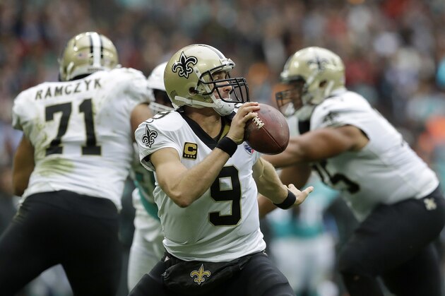 New Orleans Saints quarterback Drew Brees (9) looks to pass the ball during the first half of an NFL football game against the Miami Dolphins at Wembley Stadium in London, Sunday Oct. 1, 2017. (AP Photo/Matt Dunham)
