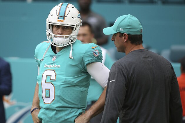 Miami Dolphins quarterback Jay Cutler (6) listens to head coach Adam Gase before an NFL preseason football game against the Baltimore Ravens, Thursday, Aug. 17, 2017, in Miami Gardens, Fla. (AP Photo/Wilfredo Lee)
