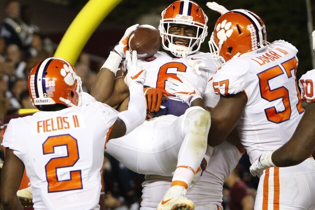 Clemson linebacker Dorian O'Daniel (6) celebrates with his teammates after a pick six during the second half of an NCAA college football game in Blacksburg, Va., Saturday, Sept. 30, 2017. Clemson won the game 31-17. (AP Photo/Steve Helber)