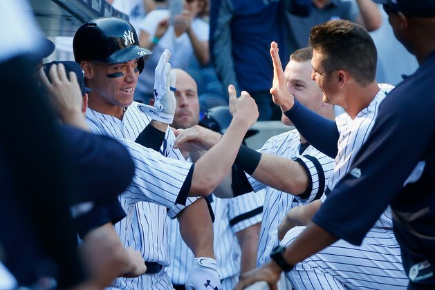 NEW YORK, NY - SEPTEMBER 25:  (NEW YORK DAILIES OUT)   Aaron Judge #99 of the New York Yankees celebrates his seventh inning home run against the Kansas City Royals with teammates Todd Frazier #29 and Greg Bird #33 (R) at Yankee Stadium on September 25, 2017 in the Bronx borough of New York City. The Yankees defeated the Royals 11-3. The home run was Judge's 50th of the season breaking the MLB rookie record set by Mark McGwire in 1987.  (Photo by Jim McIsaac/Getty Images)