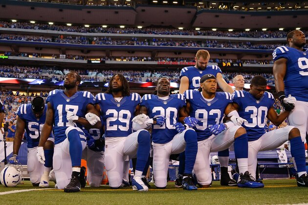 INDIANAPOLIS, IN - SEPTEMBER 24:  Members of the Indianapolis Colts stand and kneel for the national anthem prior to the start of the game between the Indianapolis Colts and the Cleveland Browns at Lucas Oil Stadium on September 24, 2017 in Indianapolis, Indiana.  (Photo by Michael Reaves/Getty Images)
