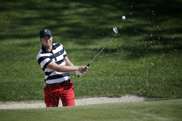 U.S. Team member Daniel Berger hits out of a trap of the fourth hole during the final round of the Presidents Cup golf tournament at Liberty National Golf Club in Jersey City, N.J., Sunday, Oct. 1, 2017. (AP Photo/Julio Cortez)