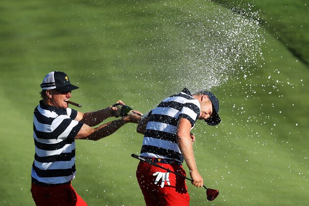 JERSEY CITY, NJ - OCTOBER 01:  Charlie Hoffman sprays Daniel Berger of the U.S. Team with champagne after Berger defeated Si Woo Kim of South Korea and the International Team on the 17th hole 2&1 to give the U.S. Team the clinching point to win the Presidents Cup during Sunday singles matches at Liberty National Golf Club on October 1, 2017 in Jersey City, New Jersey.  (Photo by Rob Carr/Getty Images)