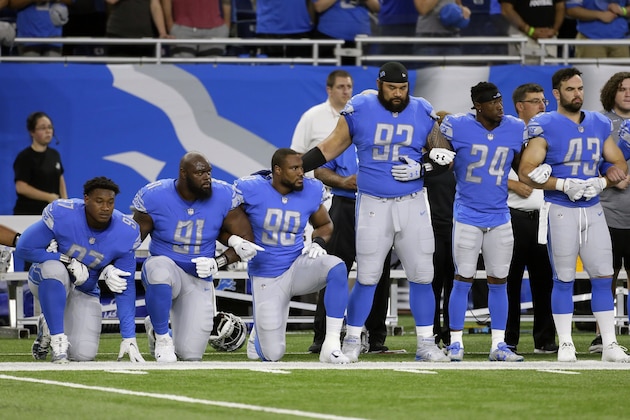 FILE- In a file photo from Sept. 24, 2017, Detroit Lions defensive end Armonty Bryant (97), defensive tackle A'Shawn Robinson (91) and defensive end Cornelius Washington (90) take a knee during the national anthem before an NFL football game against the Atlanta Falcons, in Detroit. The sight of football players kneeling during the national anthem across the United States is the continuation of a tradition nearly as old the song itself. University of Michigan musicology professor Mark Clague says