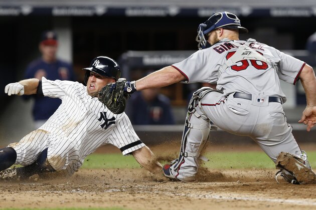 New York Yankees left fielder Brett Gardner (11) reacts after he was tagged out at the plate by Minnesota Twins catcher Chris Gimenez (38) during the seventh inning of a baseball game in New York, Tuesday, Sept. 19, 2017. The play came after the Yankees' Aaron Judge hit into a fielder's choice. (AP Photo/Kathy Willens)