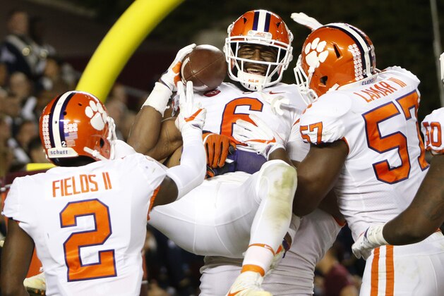Clemson linebacker Dorian O'Daniel (6) celebrates with his teammates after a pick six during the second half of an NCAA college football game in Blacksburg, Va., Saturday, Sept. 30, 2017. Clemson won the game 31-17. (AP Photo/Steve Helber)
