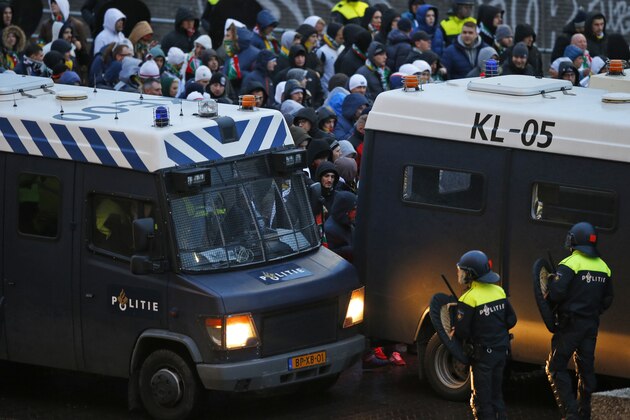 Legia Warsaw fans arrive under Dutch riot police escort for the Europa League round of 32 second leg soccer match between Ajax and Legia at the Amsterdam ArenA stadium in Amsterdam, Netherlands, Thursday, Feb. 23, 2017. (AP Photo/Peter Dejong)
