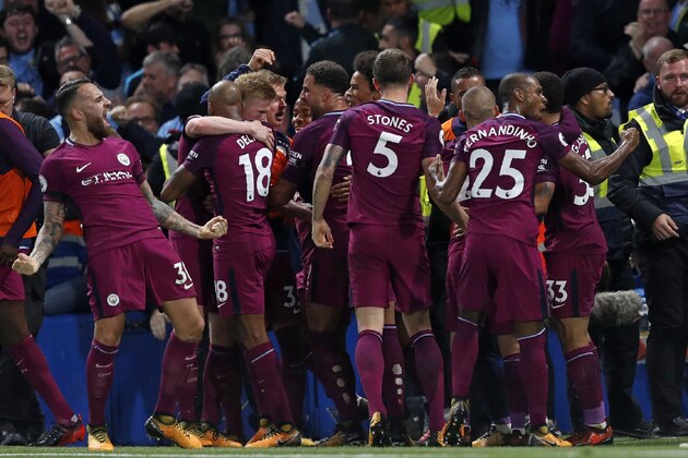 Manchester City's Belgian midfielder Kevin De Bruyne celebrates with teammates after scoring the opening goal of the English Premier League football match between Chelsea and Manchester City at Stamford Bridge in London on September 30, 2017. / AFP PHOTO / Adrian DENNIS / RESTRICTED TO EDITORIAL USE. No use with unauthorized audio, video, data, fixture lists, club/league logos or 'live' services. Online in-match use limited to 75 images, no video emulation. No use in betting, games or single club/league/player publications.  /         (Photo credit should read ADRIAN DENNIS/AFP/Getty Images)