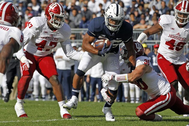 Penn State's Saquon Barkley (26) is brought down by Indiana's Chase Dutra (30) during the first half of an NCAA college football game in State College, Pa., Saturday, Sept. 30, 2017. (AP Photo/Chris Knight)