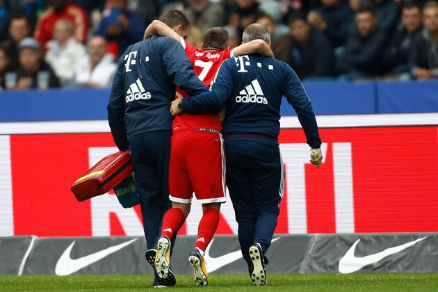 TOPSHOT - Bayern Munich's French midfielder Franck Ribery (C) is helped off the pitch by medical staff after injuring his knee during the German first division Bundesliga football match between Hertha Berlin and FC Bayern Munich in Berlin, on October 1, 2017. / AFP PHOTO / Odd ANDERSEN / ALTERNATIVE CROP         (Photo credit should read ODD ANDERSEN/AFP/Getty Images)