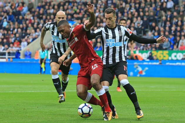 Liverpool's English striker Daniel Sturridge vies with Newcastle United's Spanish midfielder Javier Manquillo (R) during the English Premier League football match between Newcastle United and Liverpool at St James' Park in Newcastle-upon-Tyne, north east England on October 1, 2017. / AFP PHOTO / Lindsey PARNABY / RESTRICTED TO EDITORIAL USE. No use with unauthorized audio, video, data, fixture lists, club/league logos or 'live' services. Online in-match use limited to 75 images, no video emulation. No use in betting, games or single club/league/player publications.  /         (Photo credit should read LINDSEY PARNABY/AFP/Getty Images)