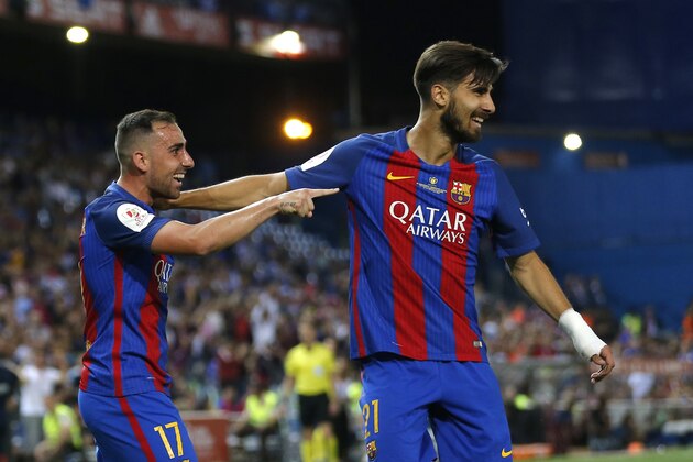 Barcelona's Paco Alcacer, left, celebrates with team mate Barcelona's Andre Gomes after scoring his team's third goal during the Copa del Rey final soccer match between Barcelona and Alaves at the Vicente Calderon stadium in Madrid, Spain, Saturday May 27, 2017. (AP Photo/Daniel Ochoa de Olza)