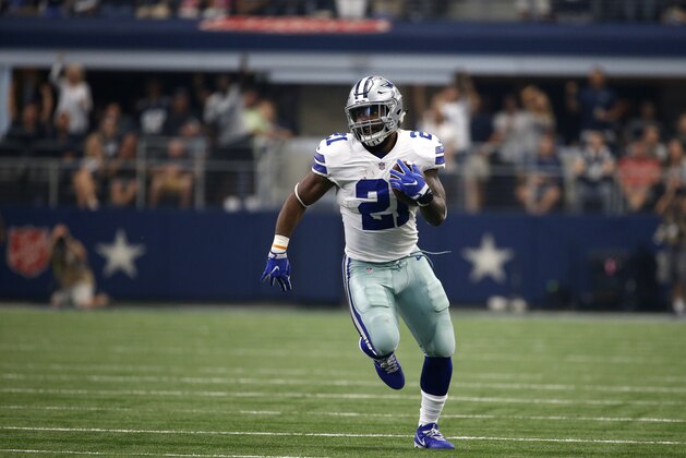 Dallas Cowboys running back Ezekiel Elliott (21) carries the ball for extra yardage after catching a pass in the first half of an NFL football game against the Los Angeles Rams on Sunday, Oct. 1, 2017, in Arlington, Texas. (AP Photo/Ron Jenkins)