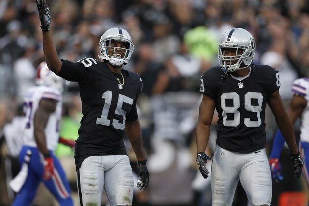 Oakland Raiders wide receiver Michael Crabtree (15) and wide receiver Amari Cooper (89) react during the second half of an NFL football game against the Buffalo Bills in Oakland, Calif., Sunday, Dec. 4, 2016. (AP Photo/D. Ross Cameron)