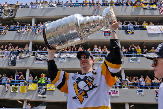 Pittsburgh Penguins' Sidney Crosby hoists the Stanley Cup while riding in the Stanley Cup victory parade in Pittsburgh, Wednesday, June 14, 2017. (AP Photo/Gene J. Puskar) Pittsburgh Penguins' Sidney Crosby hoists the Stanley Cup while riding in the Stanley Cup victory parade in Pittsburgh, Wednesday, June 14, 2017. (AP Photo/Gene J. Puskar)