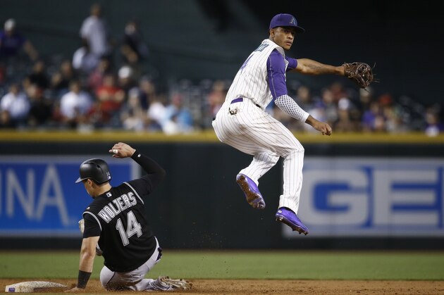 Arizona Diamondbacks' Ketel Marte, right, leaps over Colorado Rockies' Tony Wolters (14) after being forced out at second base during the sixth inning of a baseball game Thursday, Sept. 14, 2017, in Phoenix. The Diamondbacks defeated the Rockies 7-0. (AP Photo/Ross D. Franklin)